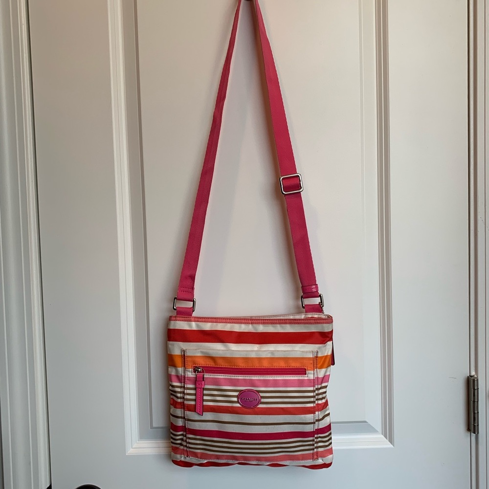 Cute Coach Crossbody Bag w/two outside pockets, Cream/Pink/Orange in color.